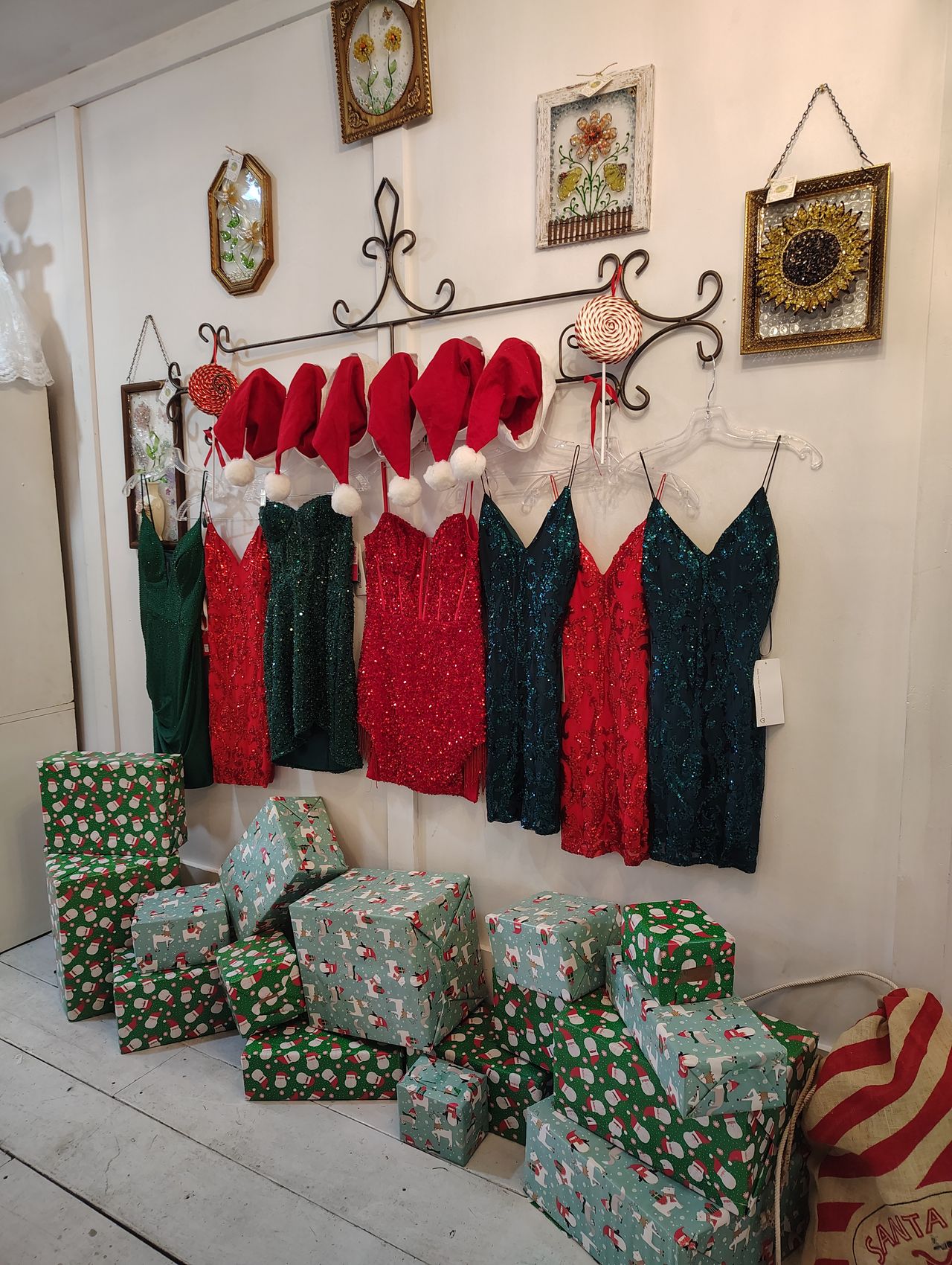 The gift shop inside Downtown Social, with sequinned dresses hanging on a rail above wrapped gifts and framed decorations